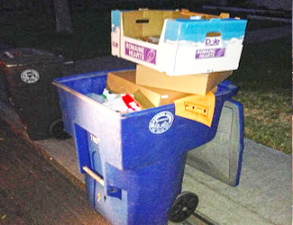 Boxes stacked on top of waste bin